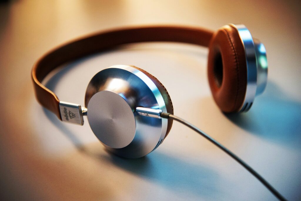 A photo of brown and metallic headphones. An image representing the use of music and/or noise cancellation as a way to manage overstimulation.