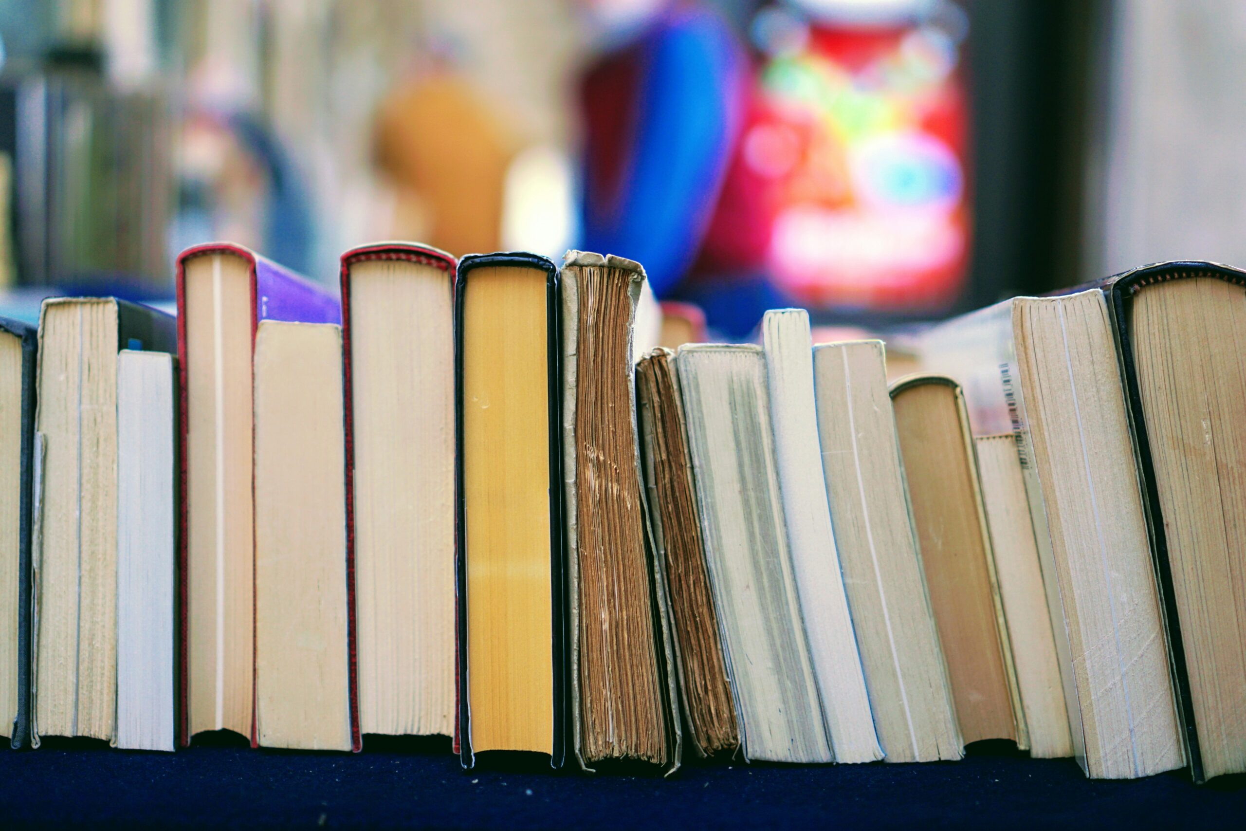 A photo representing therapy qualifications. An image with a pile of books.